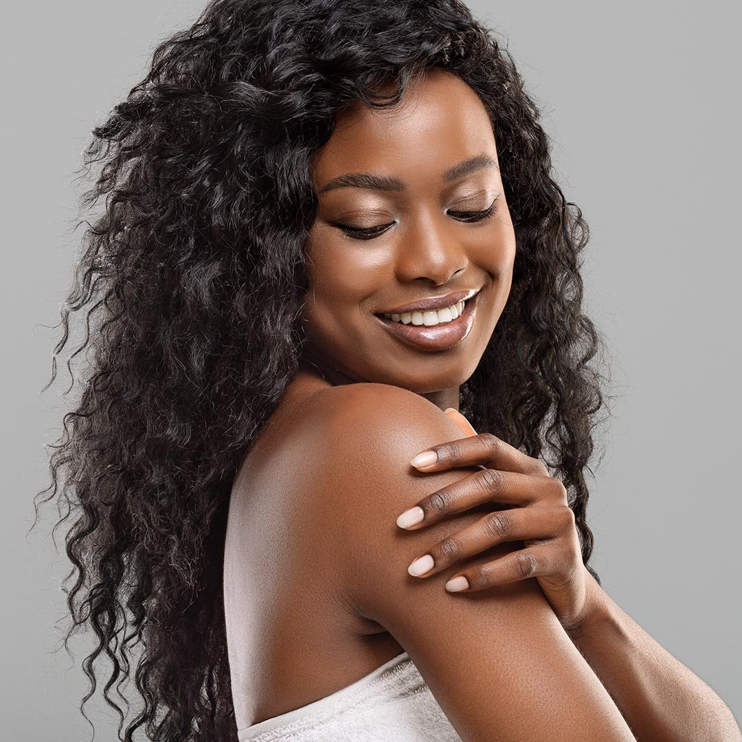 Happy woman touching her shoulder