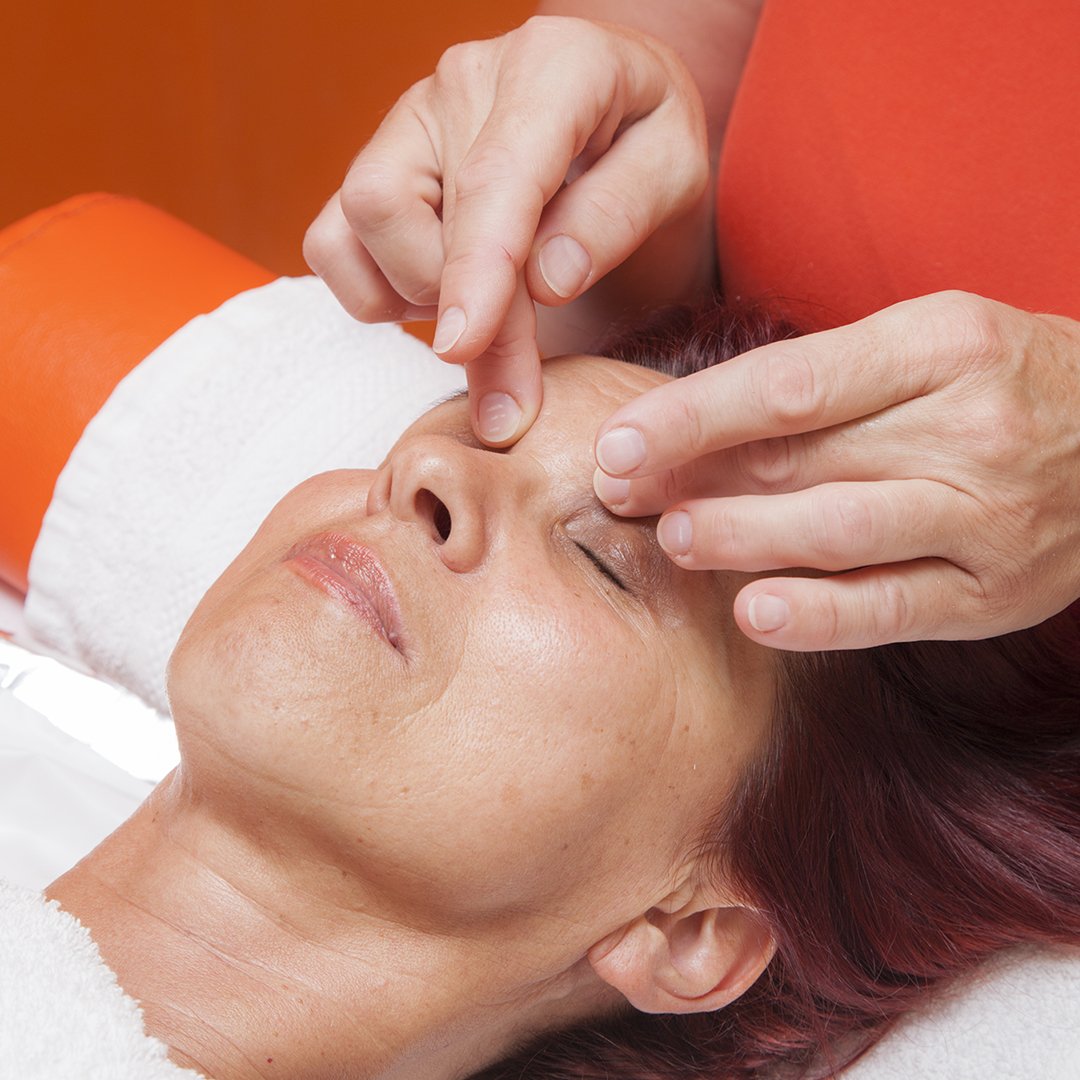 Image of a woman getting her face massaged