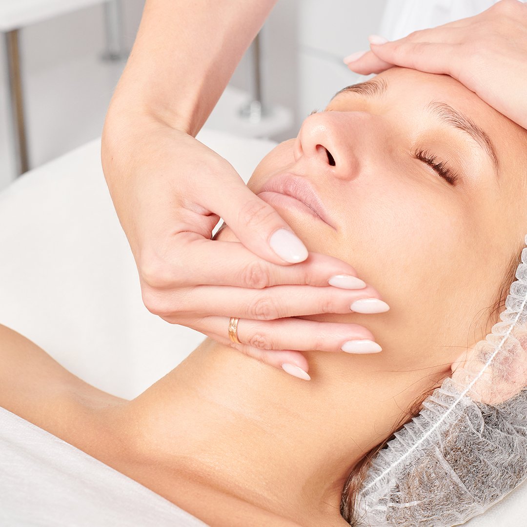 A woman getting a facial massage