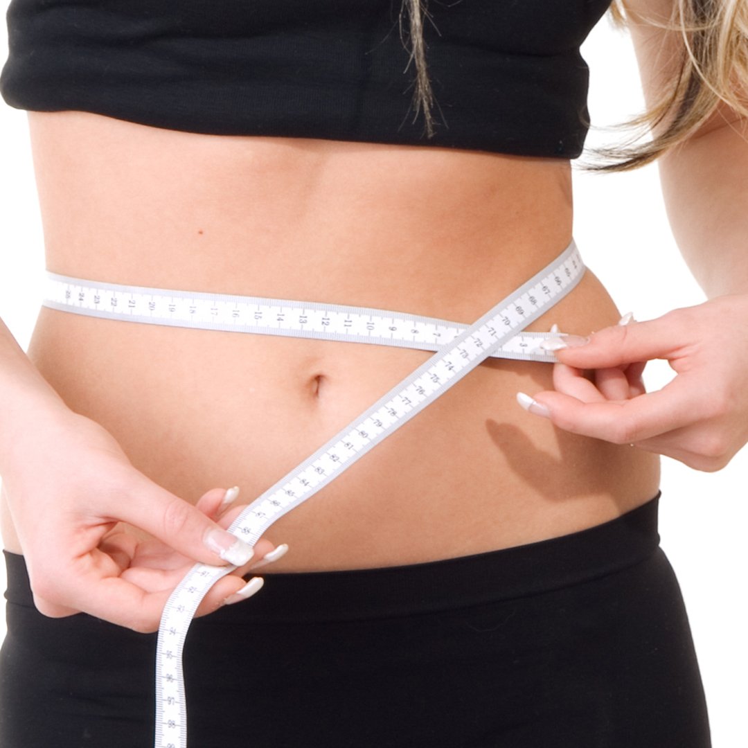 Image of a a fit woman measuring her waist