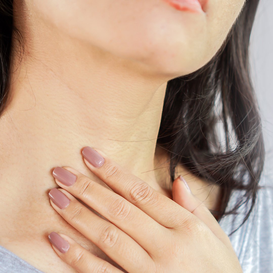 Image of a woman touching her neck