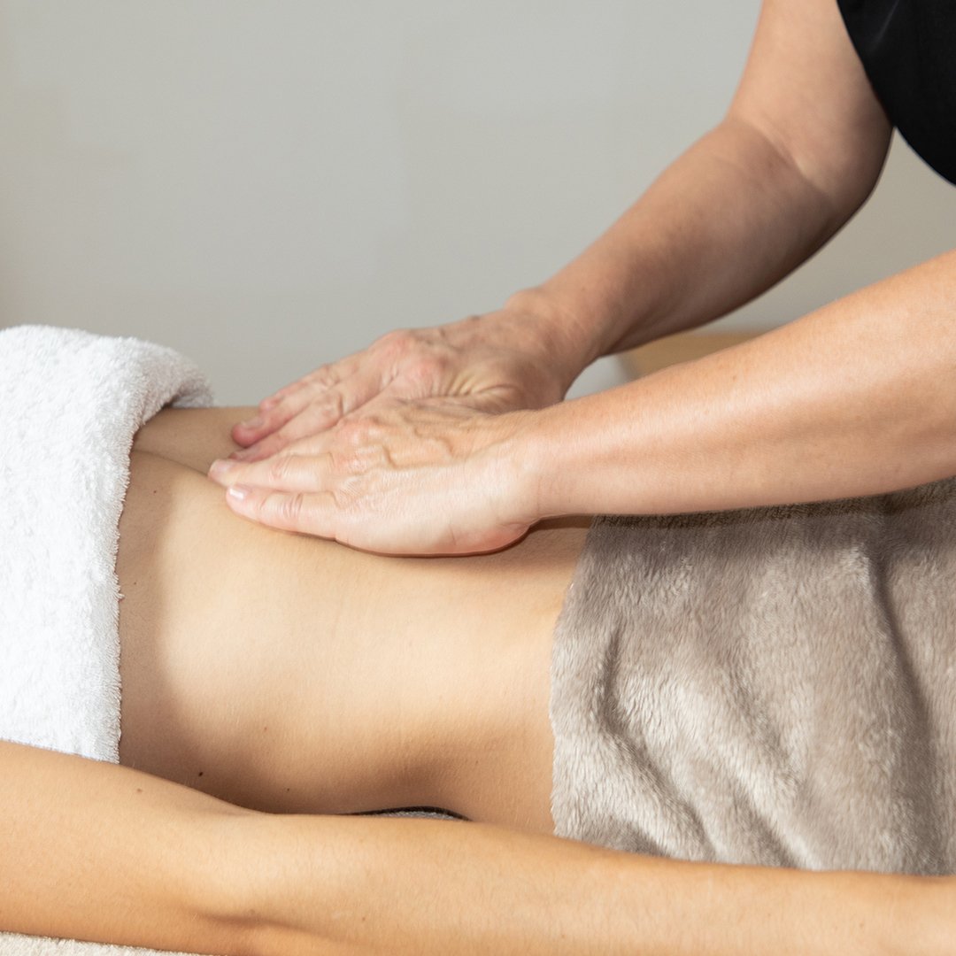 Image of a woman getting a stomach massage